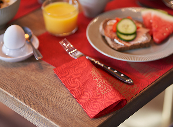 Folded Elegant Trees tissue napkin on a matching placemat